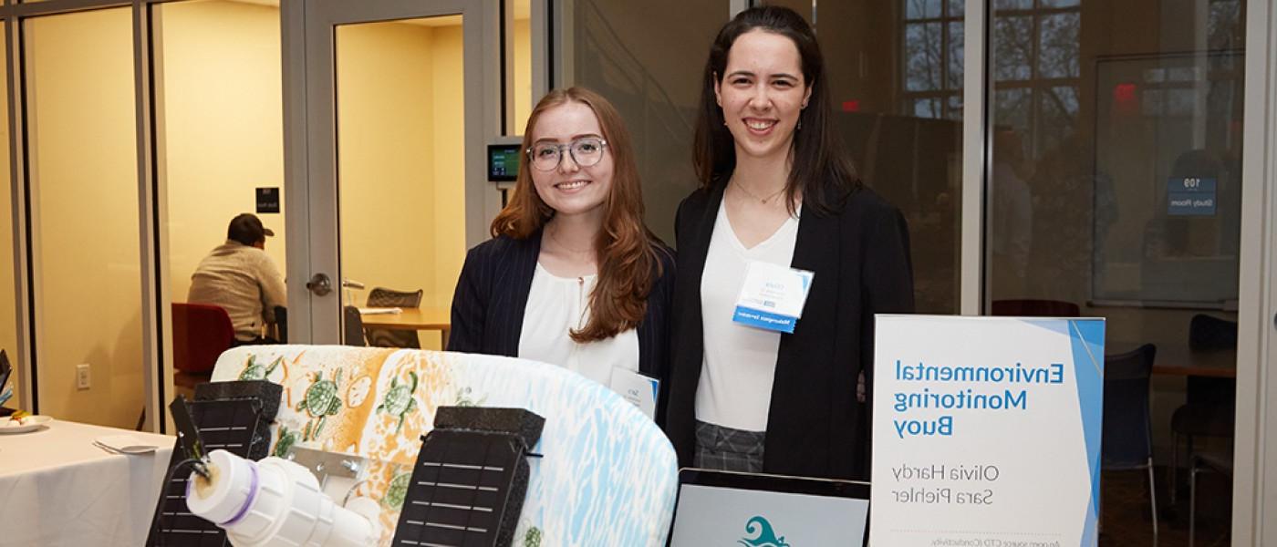 Two U N E students showing their project at the Innovation Challenge